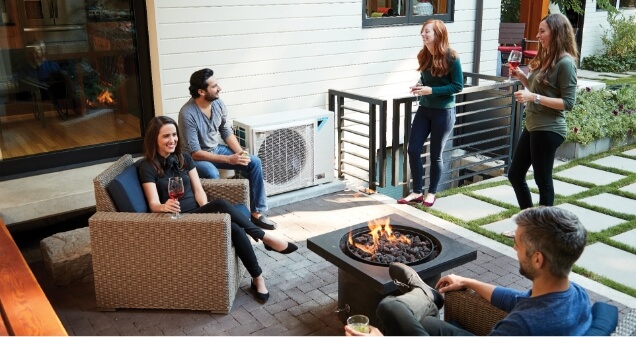 Group relaxing on the porch with a Daikin System in the background