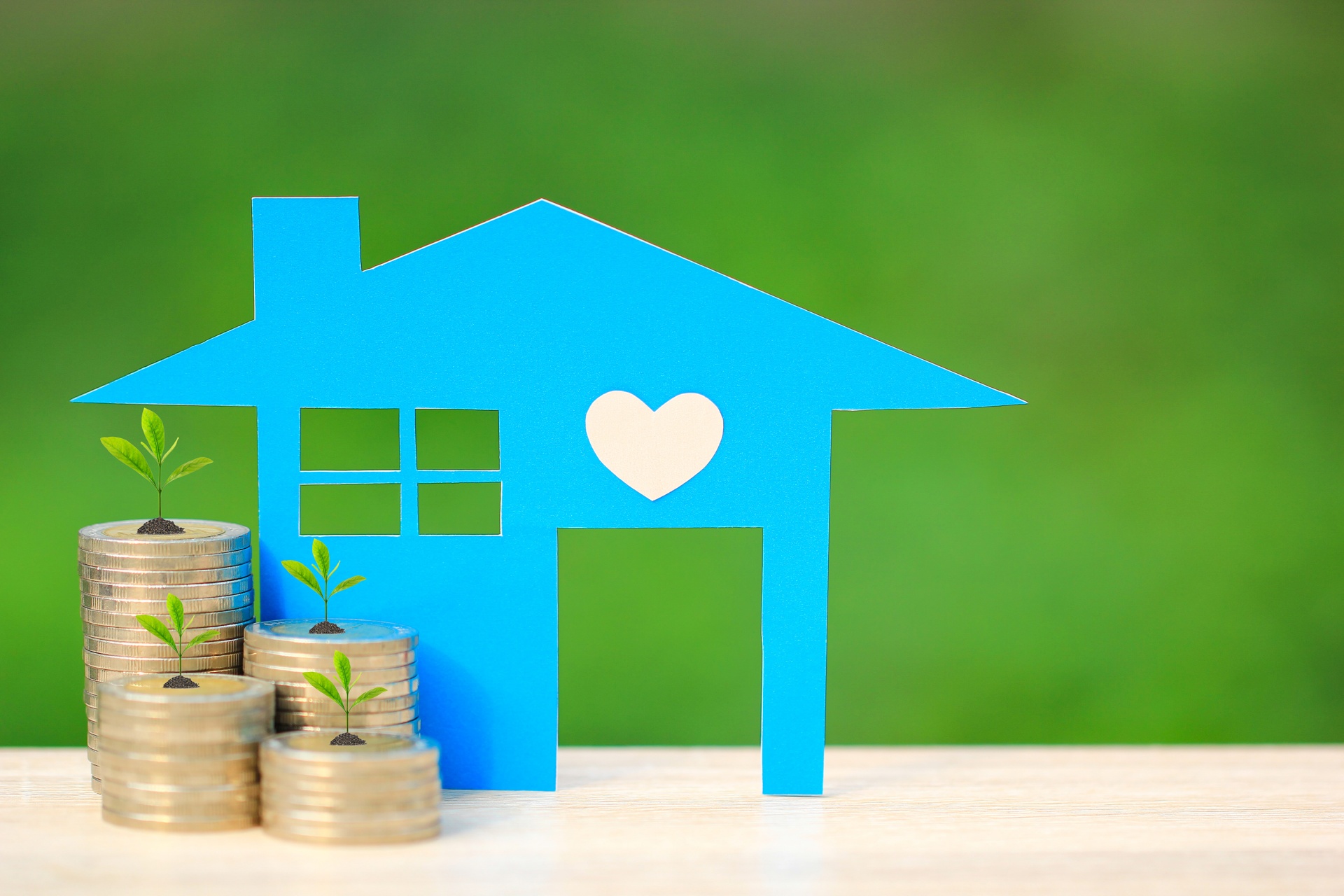 Blue house with heart, coins, and growing plants representing air conditioning repair savings.